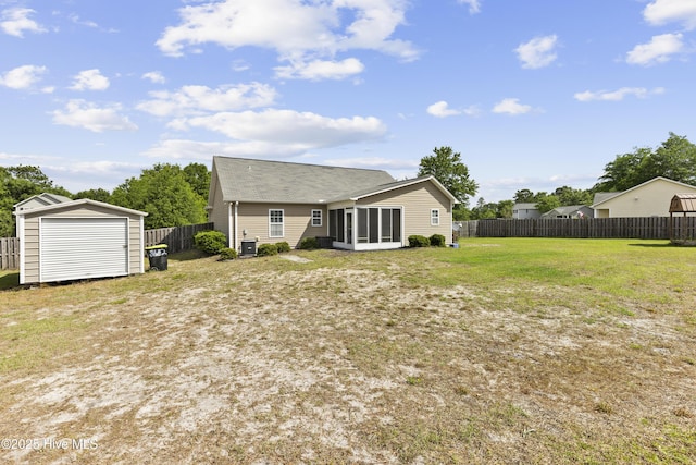8602 Heirloom Dr NE, Leland, NC 28451 - rear view of house with a fenced backyard, an outbuilding, a storage shed, a sunroom, and a lawn