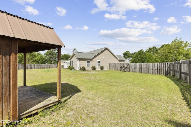 8602 Heirloom Dr NE, Leland, NC 28451 - view of yard featuring a wooden deck and a fenced backyard
