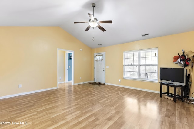 8602 Heirloom Dr NE, Leland, NC 28451 - unfurnished living room featuring light wood-style floors, vaulted ceiling, ceiling fan, baseboards, and visible vents