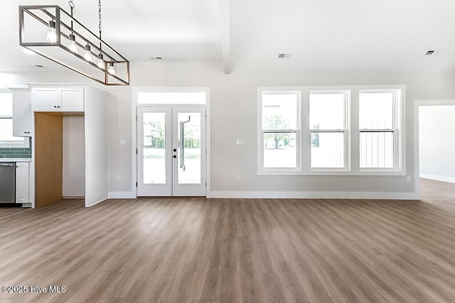 1104 Soundside Rd, Edenton, NC 27932 - unfurnished living room with baseboards, french doors, and light wood-type flooring