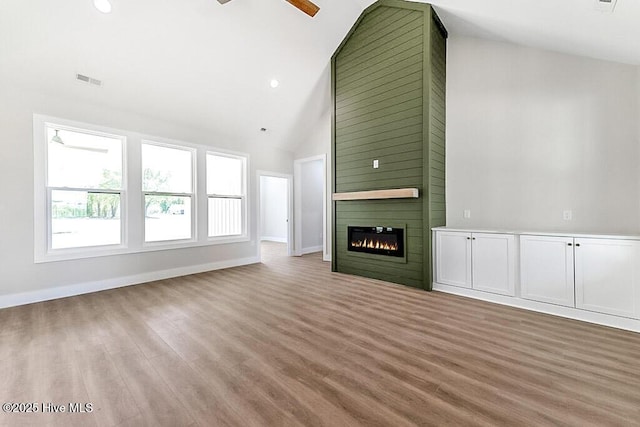 1104 Soundside Rd, Edenton, NC 27932 - unfurnished living room featuring wood finished floors, a fireplace, visible vents, baseboards, and ceiling fan