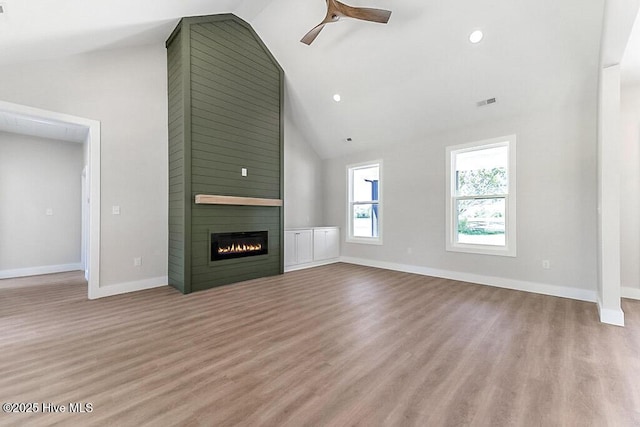 1104 Soundside Rd, Edenton, NC 27932 - unfurnished living room featuring baseboards, ceiling fan, high vaulted ceiling, wood finished floors, and a fireplace