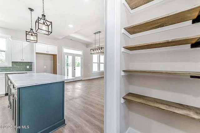 1104 Soundside Rd, Edenton, NC 27932 - kitchen with french doors, light wood-style flooring, a center island, open shelves, and white cabinets