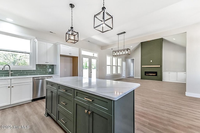 1104 Soundside Rd, Edenton, NC 27932 - kitchen with light wood finished floors, a sink, white cabinetry, stainless steel dishwasher, and decorative backsplash