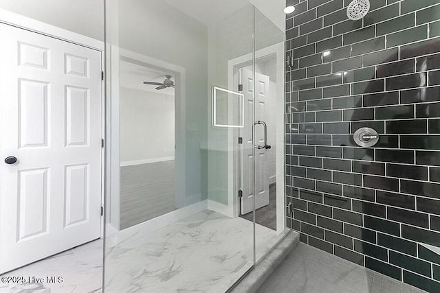 1104 Soundside Rd, Edenton, NC 27932 - bathroom featuring a tile shower, marble finish floor, baseboards, and a ceiling fan