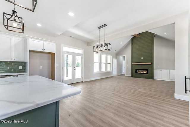 1104 Soundside Rd, Edenton, NC 27932 - kitchen featuring tasteful backsplash, french doors, recessed lighting, pendant lighting, and light wood-style floors