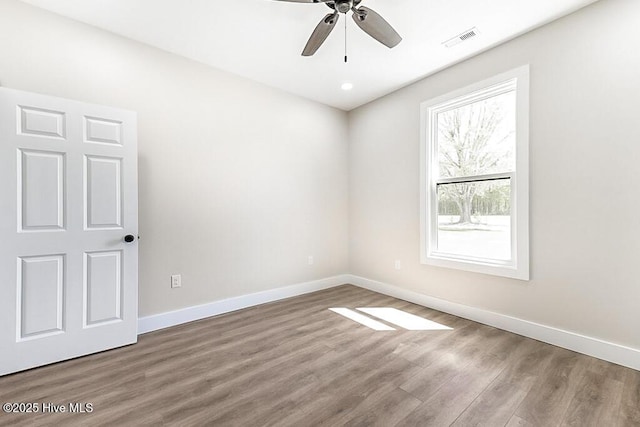 1104 Soundside Rd, Edenton, NC 27932 - unfurnished room featuring baseboards, visible vents, wood finished floors, and a ceiling fan