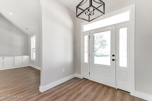 1104 Soundside Rd, Edenton, NC 27932 - foyer with an inviting chandelier, wood finished floors, baseboards, and lofted ceiling