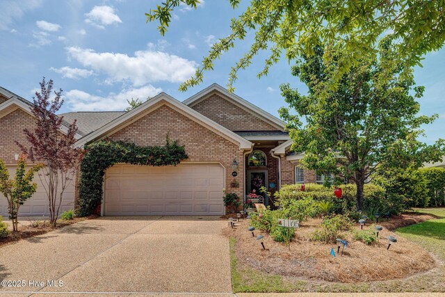 1105 Avebury Ct, Leland, NC 28479 - ranch-style house featuring brick siding, an attached garage, and concrete driveway