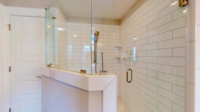full bathroom featuring tile walls and a shower stall