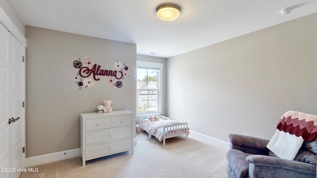 bedroom featuring baseboards and light colored carpet