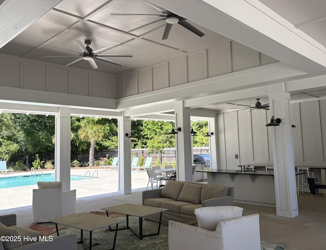 living room with ceiling fan and a healthy amount of sunlight