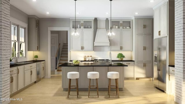 473 White Heron Ct SW, Sunset Beach, NC 28468 - kitchen featuring a sink, dark countertops, stainless steel appliances, light wood finished floors, and custom exhaust hood