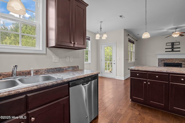 110 Costa Ct, Sneads Ferry, NC 28460 - kitchen with dishwasher, a sink, dark wood-type flooring, a ceiling fan, and a stone fireplace