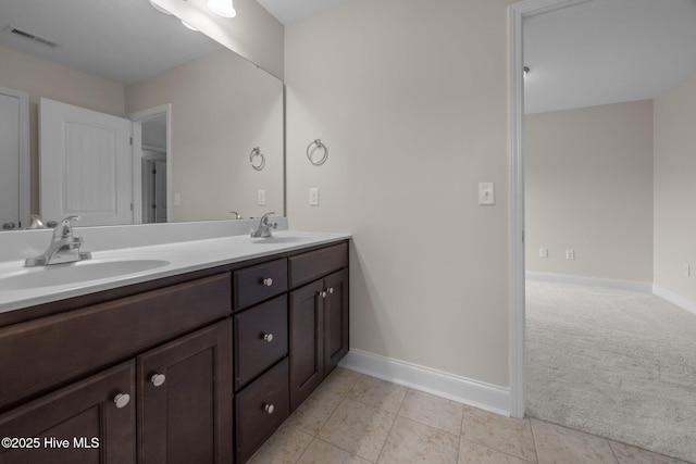 110 Costa Ct, Sneads Ferry, NC 28460 - bathroom featuring baseboards, double vanity, and tile patterned floors