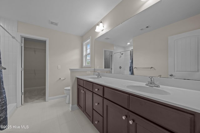 110 Costa Ct, Sneads Ferry, NC 28460 - full bathroom with a shower stall, double vanity, toilet, baseboards, and a walk in closet