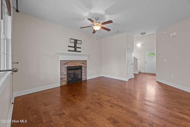 110 Costa Ct, Sneads Ferry, NC 28460 - unfurnished living room with ceiling fan, hardwood / wood-style floors, a stone fireplace, and baseboards