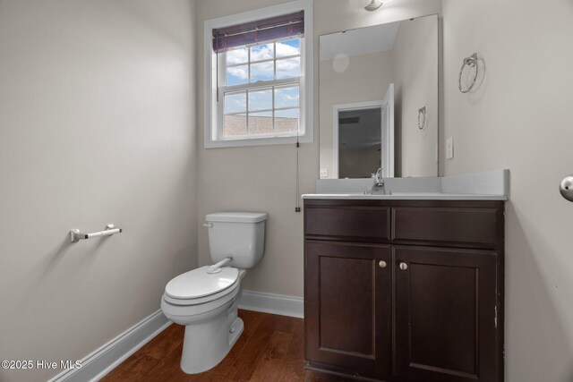 110 Costa Ct, Sneads Ferry, NC 28460 - bathroom with baseboards, wood finished floors, toilet, and vanity