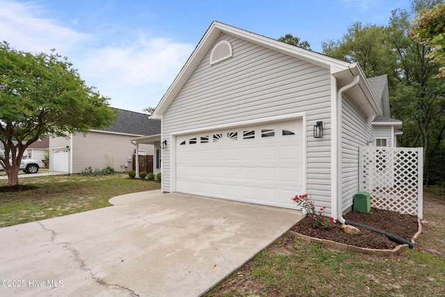 garage featuring concrete driveway