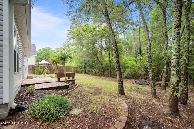 view of yard with fence and a wooden deck