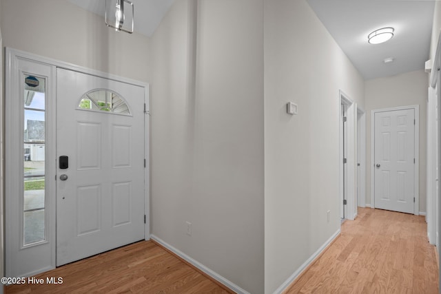 entryway featuring light wood-style flooring and baseboards