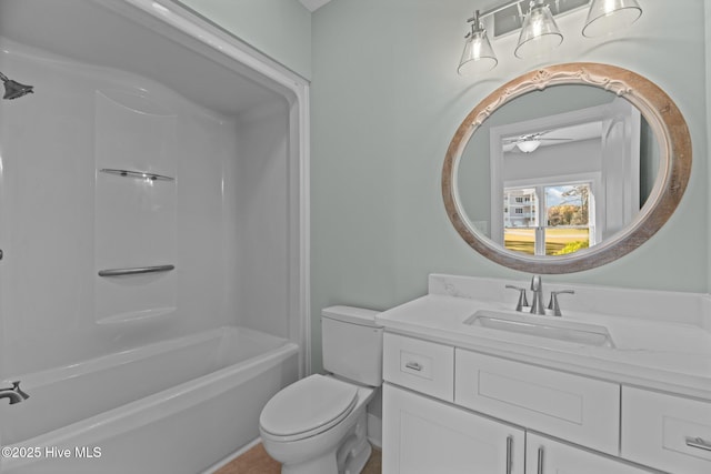 full bathroom featuring a ceiling fan, toilet,  shower combination, and vanity