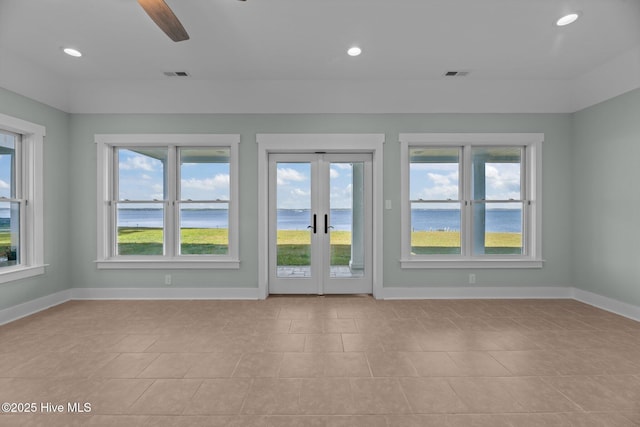 unfurnished living room with visible vents, recessed lighting, baseboards, and a water view