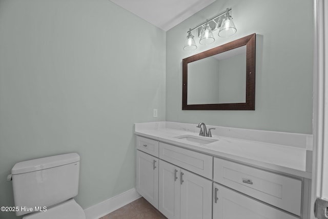 half bath featuring toilet, baseboards, tile patterned flooring, and vanity