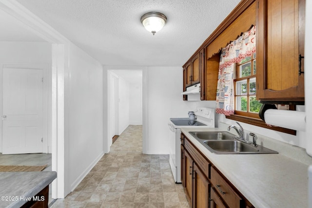 310 Chicopee Rd, Benson, NC 27504 - kitchen with white range with electric stovetop, under cabinet range hood, a textured ceiling, brown cabinets, and light countertops