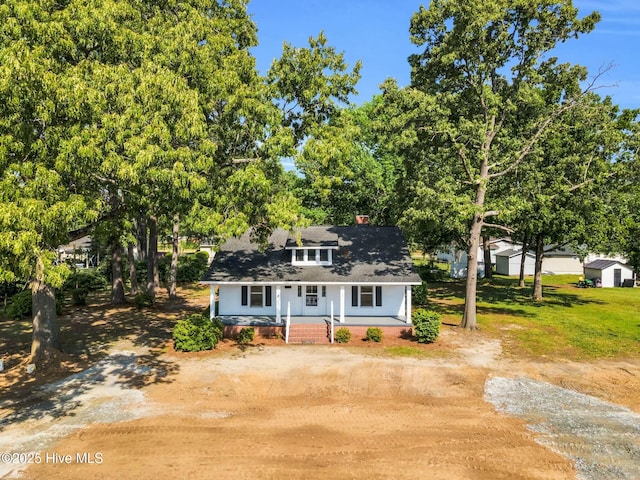 310 Chicopee Rd, Benson, NC 27504 - bungalow with a porch, dirt driveway, and view of scattered trees