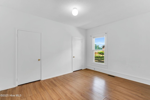 310 Chicopee Rd, Benson, NC 27504 - unfurnished bedroom featuring light wood-style floors and baseboards