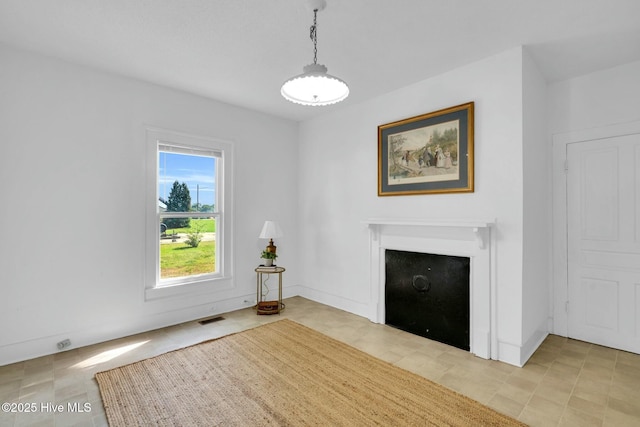 310 Chicopee Rd, Benson, NC 27504 - unfurnished living room featuring a fireplace with flush hearth and light tile patterned floors