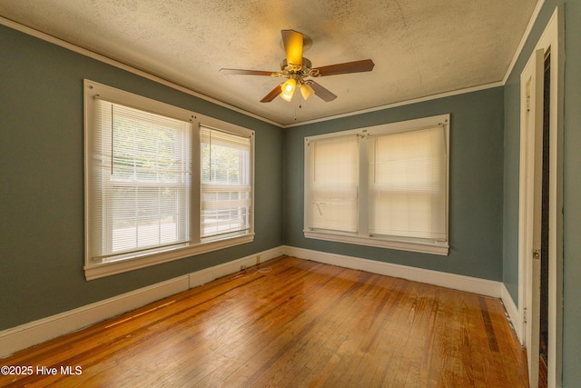 503 Spring St, Hamlet, NC 28345 - unfurnished room with baseboards, hardwood / wood-style flooring, a textured ceiling, ornamental molding, and a ceiling fan