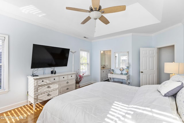 bedroom featuring crown molding, visible vents, wood finished floors, baseboards, and a ceiling fan