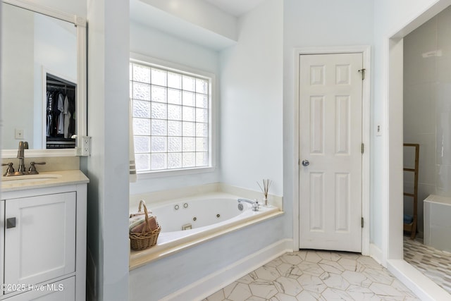 full bathroom with a whirlpool tub, tile patterned floors, a wealth of natural light, and vanity