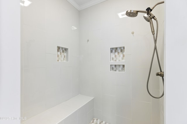 full bathroom with crown molding and a tile shower