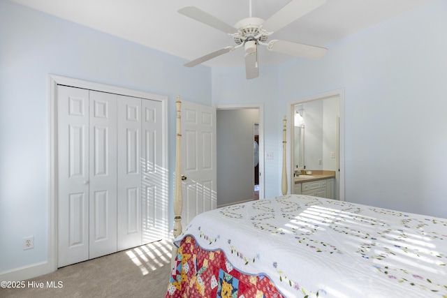 bedroom featuring a sink, a ceiling fan, a closet, and light colored carpet