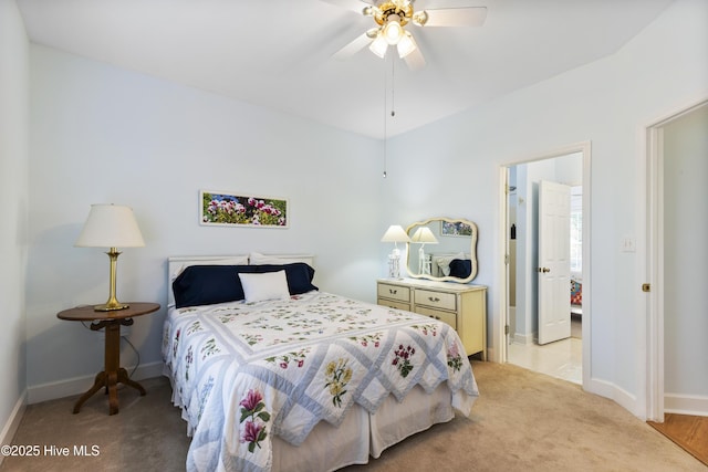 bedroom featuring baseboards, ceiling fan, and light colored carpet