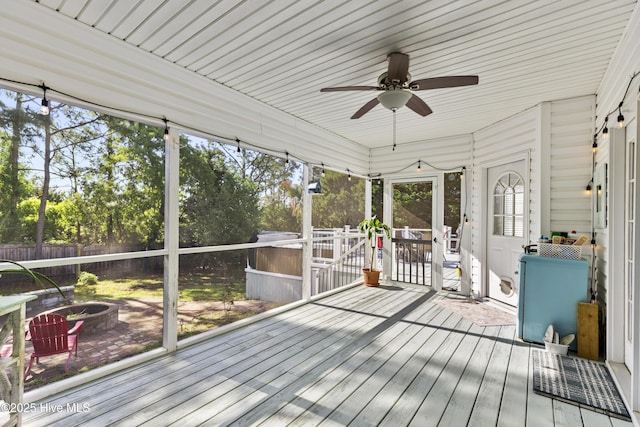 unfurnished sunroom with plenty of natural light and ceiling fan