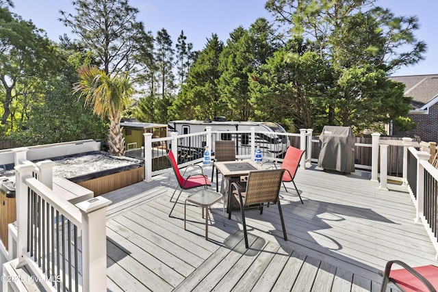 wooden deck featuring a storage unit, an outdoor structure, and a fire pit