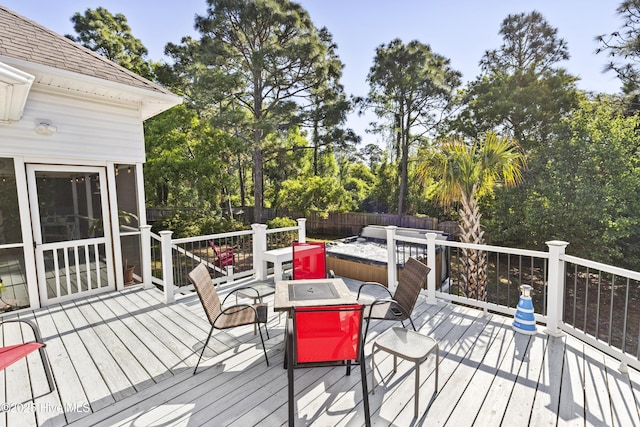 wooden terrace featuring outdoor dining space and a fenced backyard