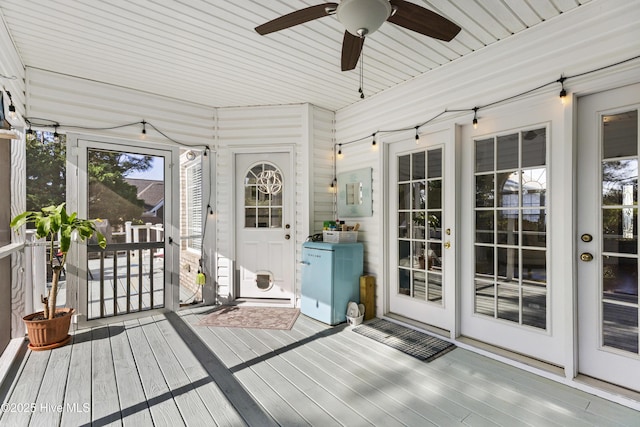 unfurnished sunroom featuring french doors, electric panel, and a ceiling fan