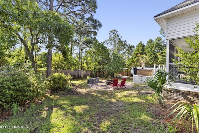 view of yard featuring fence private yard and an outdoor fire pit