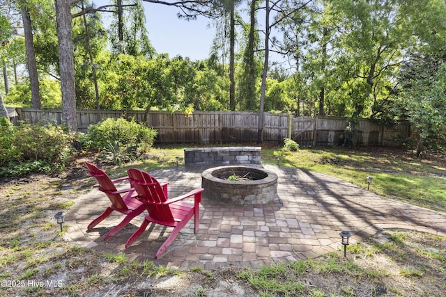 view of patio / terrace featuring a fenced backyard and a fire pit