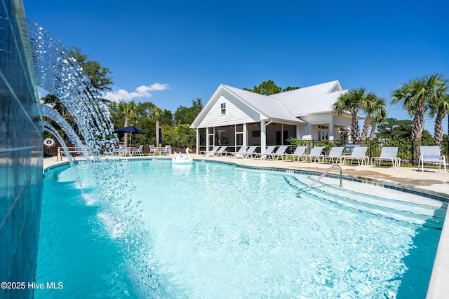 pool featuring a sunroom, fence, and a patio