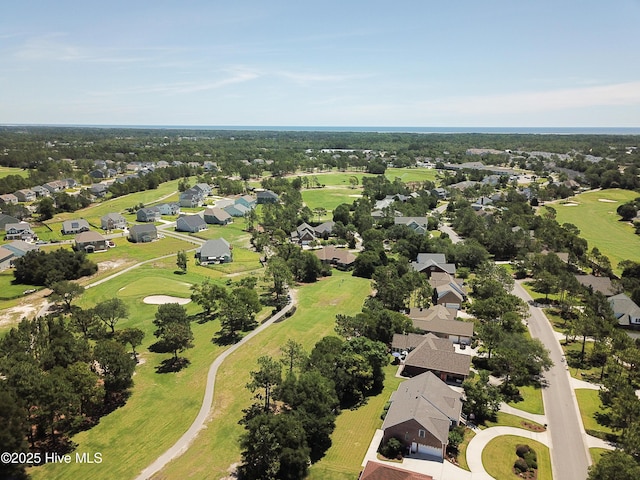 drone / aerial view with golf course view and a residential view