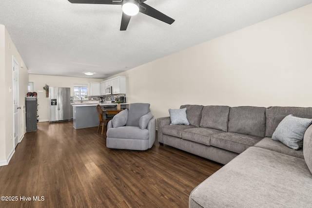 601 Pelletier Loop Rd Unit M76Silver, Creek Townhomes, Peletier, NC 28584 - living room featuring dark wood-style floors, ceiling fan, and a textured ceiling