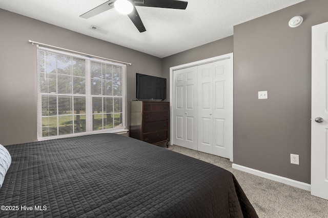 601 Pelletier Loop Rd Unit M76Silver, Creek Townhomes, Peletier, NC 28584 - carpeted bedroom featuring multiple windows, baseboards, a ceiling fan, a closet, and a textured ceiling