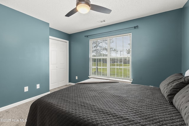 601 Pelletier Loop Rd Unit M76Silver, Creek Townhomes, Peletier, NC 28584 - bedroom with carpet flooring, a textured ceiling, a closet, a ceiling fan, and baseboards