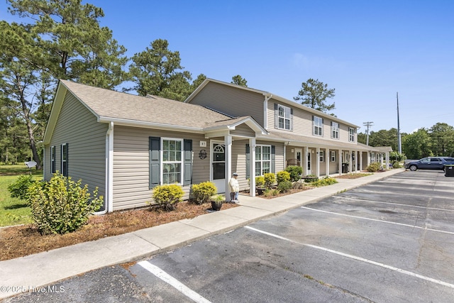 601 Pelletier Loop Rd Unit M76Silver, Creek Townhomes, Peletier, NC 28584 - view of front of house featuring uncovered parking, roof with shingles, and covered porch